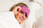 Woman wearing eye mask in bed