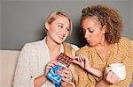 Woman offering friend chocolate