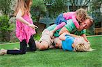 Father playing with his daughters in garden