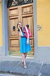 Young woman on street, using cellphone