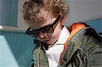 Little boy wearing mod style sunglasses and parka