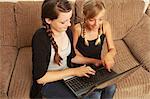 Two girls using laptop