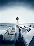 Captain at helm of large motor yacht