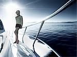 Woman standing on deck of yacht