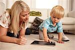 Mother and son using digital tablet