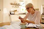 Woman with laptop holding credit card