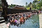 Balinese people in holy spring water in the sacred pool at Pura Tirta Empul Temple, Tampaksiring, Bali, Indonesia, Southeast Asia, Asia