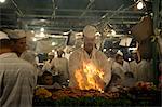 A chef grilling meat at one of the many nightly food stalls in the main square, Jemaa el Fna, in Marrakech, Morocco, North Africa, Africa