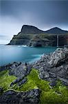 Dramatic coastline and waterfall at Gasadalur on the Island of Vagar, Faroe Islands, Denmark, Europe