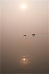 Fishing boat and river ferry on the River Ganges in the early morning, Sonepur, Bihar, India, Asia