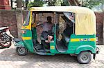 Rickshaw wallah waiting for custom in his rickshaw (tuk tuk), Barrackpore, West Bengal, India, Asia