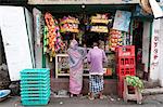 Man and woman shopping at local shop in Kumartuli district of Kolkata, West Bengal, India, Asia