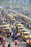 Yellow Kolkata taxis and commuters outside Howrah Railway Station in morning rush hour, Howrah, Kolkata (Calcutta), West Bengal, India, Asia