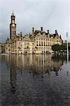 Bradford City Hall, a Venetian Gothic facade, reflects in Centenary Square fountain, Bradford, West Yorkshire, Yorkshire, England, United Kingdom, Europe