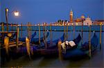 Gondolas moored on the Lagoon, San Giorgio Maggiore beyond, Riva degli Schiavoni at dusk, Venice, UNESCO World Heritage Site, Veneto, Italy, Europe