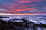 Fiery sunset over a snow covered Gormire Lake, North Yorkshire, Yorkshire, England, United Kingdom, Europe
