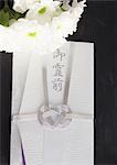 Spray mums and a condolence-money envelope (Mourning image)