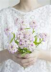 Hands holding a flower bouquet