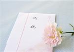 Congratulatory gift envelope and a rose