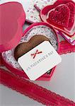 Heart-shaped chocolate and a message card