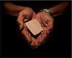 Close-up of Woman's Hands holding torn and wrinkled piece of Paper, Studio Shot