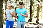 Smiling couple running in park