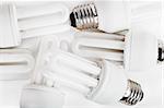 Heap of energy saver bulbs over white background