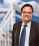 Handsome Businessman in Suit and Tie Smiling Outside of Corporate Building.