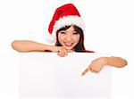 Isolated young christmas woman pointing at a blank sign