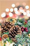 Christmas Decoration Garland with Poinsettia Pine Cones and Blurred Bokeh Lights Background Portrait