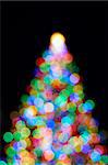 Christmas Tree with Colorful Out of Focus Blurred Light on Black Background