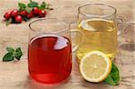 Lemon and rosehip tea in glasses on a wooden table