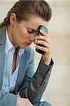 Concerned business woman with mobile phone