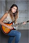 Portrait of Teenage Girl Playing Electric Guitar