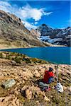 Hiker Resting at McArthur Lake, Yoho National Park, British Columbia, Canada