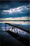 Dock with Wagon Wheel Details on Still Lake with Storm Clouds Overhead, King Bay, Point Au Fer, Champlain, New York State, USA