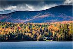 Cottage on Silver Lake with Dark Clouds Overhead, New York State, USA