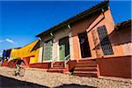 Man on Bicycle Riding Past Colorful Houses, Trinidad, Cuba