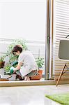 Mid adult woman gardening on the balcony