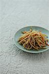 Sauteed burdock on a table