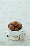 Cup of chocolate truffles on a table
