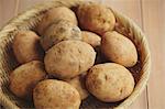 Potatoes in a wooden basket on a table