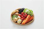 Mixed vegetables in a wooden basket on the table