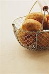 Potatoes in a metal basket on a table