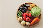 Mixed vegetables in a wooden basket on the table