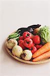 Mixed vegetables in a wooden basket on the table