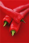 Chilli peppers on red background