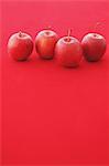 Red apples on red background