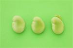 Broad beans on green background