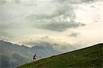 A man jogging in the mountains, Italy.